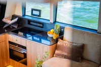 Luxurious Super Lauwersmeer SLX54 yacht interior with modern kitchen and comfortable seating, 2025 model.