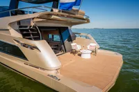 Luxurious 2025 Super Lauwersmeer SLX54 yacht on serene water, featuring elegant deck seating.