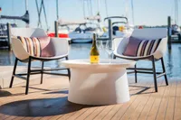 Outdoor seating on Super Lauwersmeer SLX54 yacht with wine, glasses, and marina view.