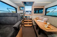 Interior of 2025 Super Lauwersmeer SLX54 yacht, featuring modern seating and dining area.