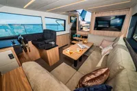Luxurious interior of 2025 Super Lauwersmeer SLX54 yacht with modern seating and panoramic windows.