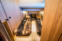 Twin cabin in 2025 Super Lauwersmeer SLX54 yacht with modern wood paneling.