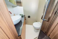 Modern bathroom in 2025 Super Lauwersmeer SLX54 yacht with sleek fixtures and wood accents.