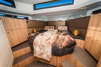 Luxurious bedroom interior of 2025 Super Lauwersmeer SLX54 yacht with modern design and cozy bedding.