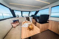 Luxurious interior of 2025 Super Lauwersmeer SLX54 yacht with modern furnishings and panoramic windows.