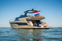 Luxurious 2025 Super Lauwersmeer SLX54 yacht on calm water, featuring sleek design and spacious deck.