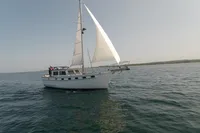 1984 Island Trader 40 sailboat cruising on open water under clear skies.