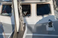 1984 Island Trader 40 sailboat docked, showcasing cabin and mast in a marina setting.