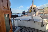 1984 Island Trader 40 yacht deck with wooden flooring and clear sky.