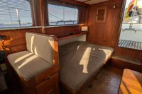 1984 Island Trader 40 interior with wooden paneling and cushioned seating.