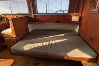 1984 Island Trader 40 interior with wooden paneling and cozy seating area.