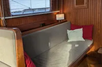 Interior of 1984 Island Trader 40 sailboat with cozy seating and wooden paneling.