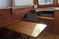 Interior of 1984 Island Trader 40 yacht with wooden dining area and seating.