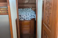 1984 Island Trader 40 cabin interior with wooden finish and cozy bedding.