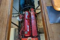 Engine compartment of a 1984 Island Trader 40 sailboat, featuring a red engine.