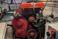 Engine room of 1984 Island Trader 40 with red engine and visible wiring.