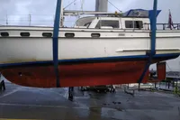 1984 Island Trader 40 sailboat in dry dock, suspended for maintenance.