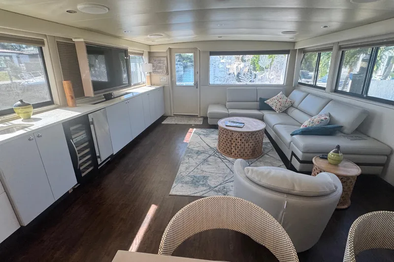 Music Yacht Photos Pics Luxurious interior of 1989 Hatteras 65 Motor Yacht with modern furnishings and large windows.