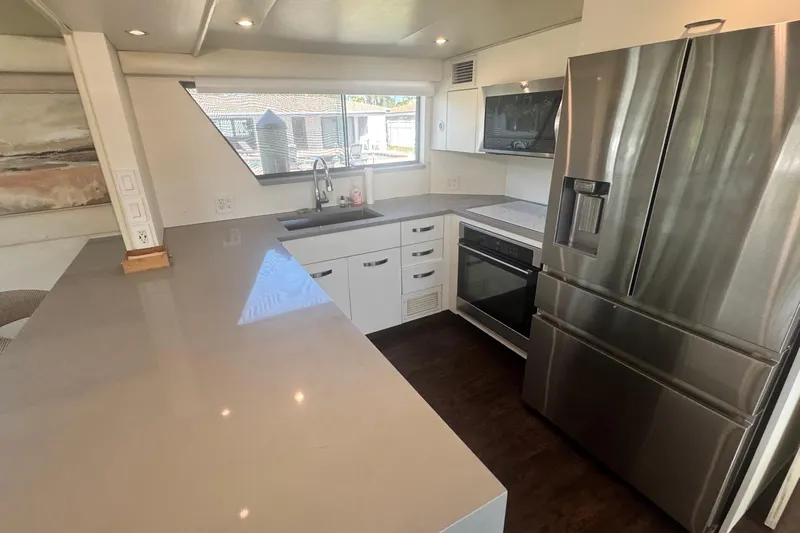 Music Yacht Photos Pics Modern kitchen interior on 1989 Hatteras 65 Motor Yacht with stainless steel appliances.