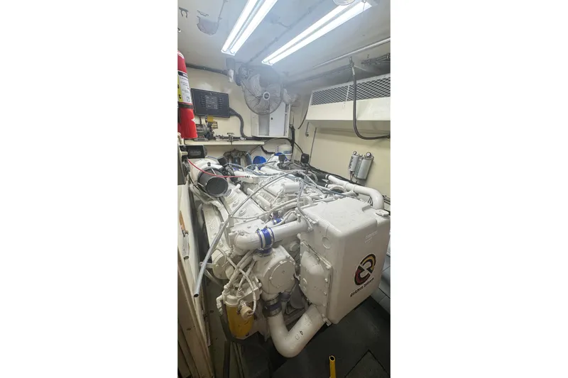 Music Yacht Photos Pics Engine room of a 1989 Hatteras 65 Motor Yacht with visible machinery and equipment.