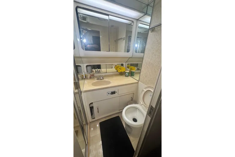 Music Yacht Photos Pics Luxurious bathroom in 1989 Hatteras 65 Motor Yacht with modern fixtures and elegant decor.