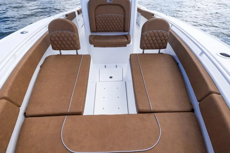  Yacht Photos Pics 2026 Sea Hunt Ultra 275 SE boat interior with brown cushioned seating and ocean backdrop.