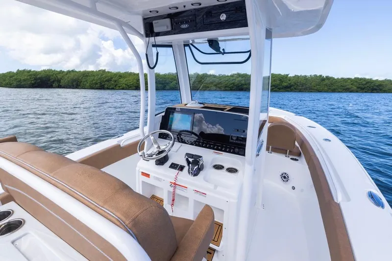  Yacht Photos Pics 2026 Sea Hunt Ultra 275 SE boat interior with helm, steering wheel, and seating on open water.