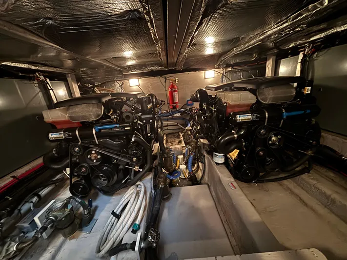 Tre Bella Yacht Photos Pics Engine room of a 2005 Sea Ray 390 Motor Yacht, featuring dual engines and equipment.