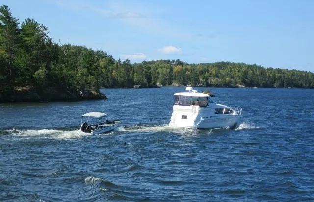 Tre Bella Yacht Photos Pics 2005 Sea Ray 390 Motor Yacht cruising on a scenic lake with lush green shoreline.