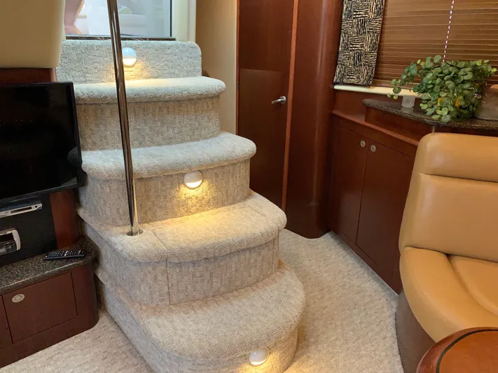 Tre Bella Yacht Photos Pics Interior of 2005 Sea Ray 390 Motor Yacht with carpeted stairs and cozy seating area.