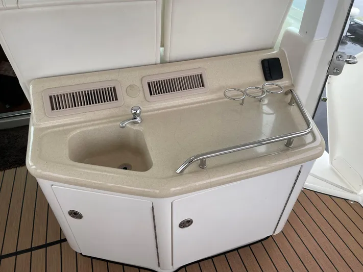 Tre Bella Yacht Photos Pics 2005 Sea Ray 390 Motor Yacht sink area with countertop and storage cabinets.