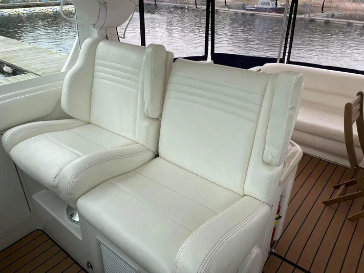 Tre Bella Yacht Photos Pics 2005 Sea Ray 390 Motor Yacht interior with white leather seating and wooden flooring.