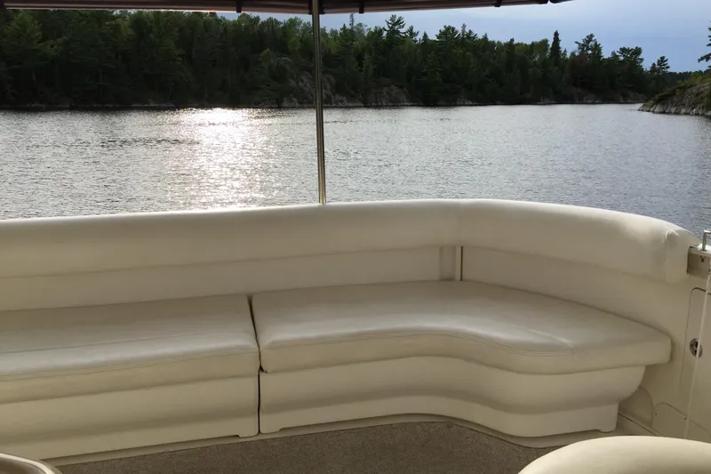 Tre Bella Yacht Photos Pics 2005 Sea Ray 390 Motor Yacht interior with white seating, overlooking serene lake and forest.