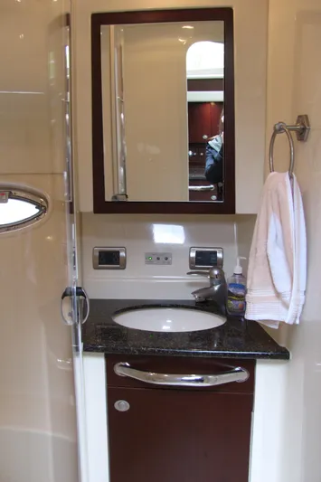 Tre Bella Yacht Photos Pics Bathroom interior of 2005 Sea Ray 390 Motor Yacht with sink, mirror, and towel.