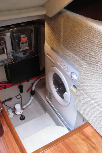 Tre Bella Yacht Photos Pics Laundry area in 2005 Sea Ray 390 Motor Yacht with washer and electrical panel.