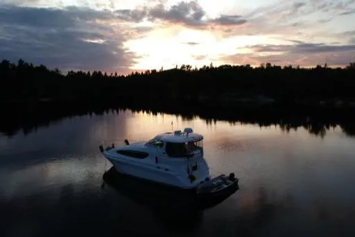 Tre Bella Yacht Photos Pics 2005 Sea Ray 390 Motor Yacht at sunset on tranquil lake.