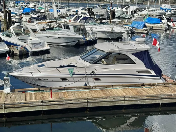 Clintessa Yacht Photos Pics 2012 Regal 35 Sport Coupe docked at marina with other boats.