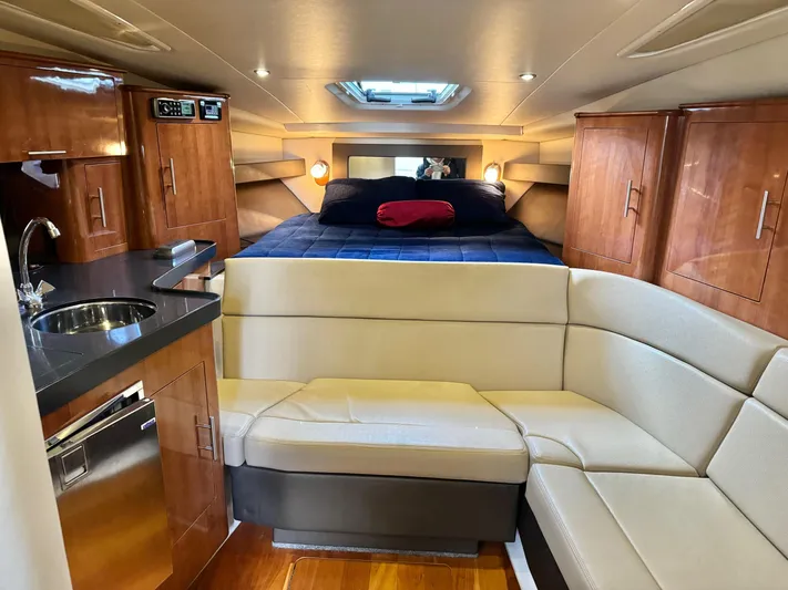 Clintessa Yacht Photos Pics Interior of 2012 Regal 35 Sport Coupe with cozy seating, kitchenette, and bed.