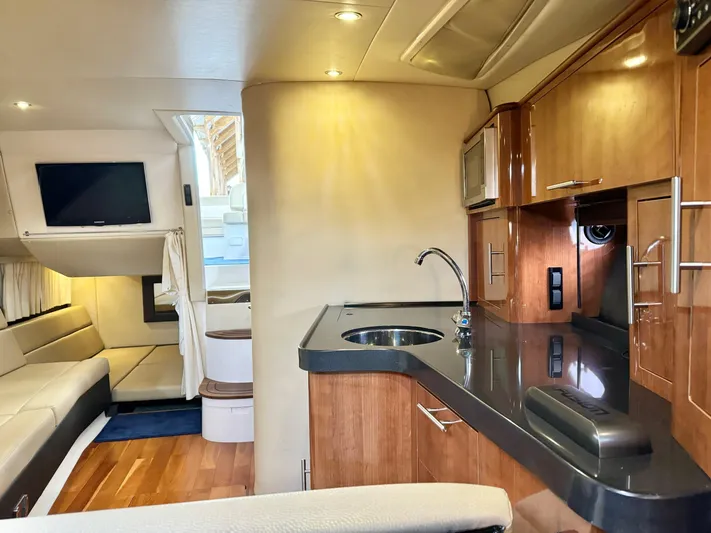 Clintessa Yacht Photos Pics Luxurious interior of 2012 Regal 35 Sport Coupe with modern kitchen and seating area.