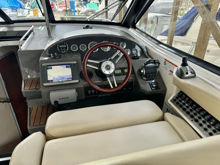 Clintessa Yacht Photos Pics 2012 Regal 35 Sport Coupe cockpit with steering wheel, navigation system, and control panel.