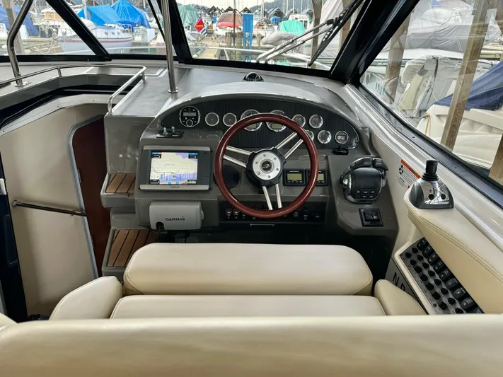 Clintessa Yacht Photos Pics 2012 Regal 35 Sport Coupe cockpit with steering wheel, navigation system, and control panel.