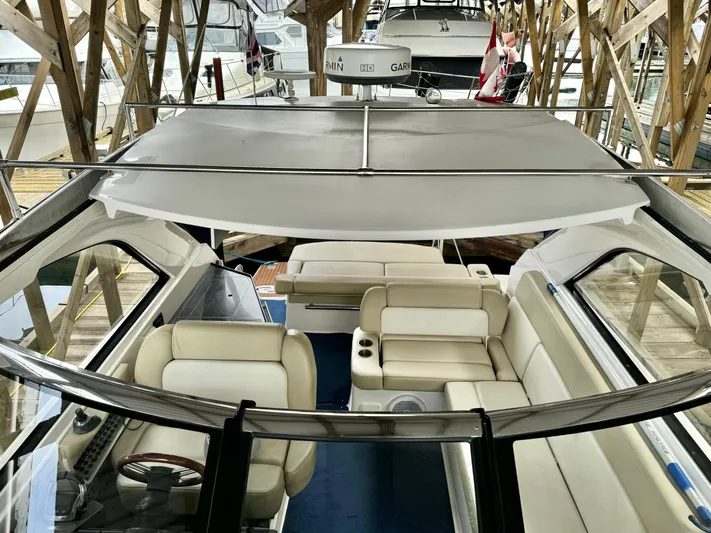 Clintessa Yacht Photos Pics 2012 Regal 35 Sport Coupe with spacious seating and modern design in a marina setting.