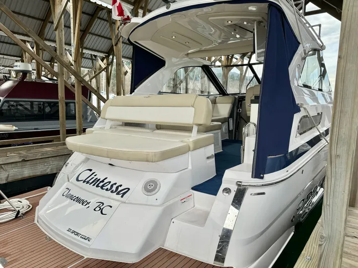 Clintessa Yacht Photos Pics 2012 Regal 35 Sport Coupe yacht docked, featuring a spacious seating area and elegant design.