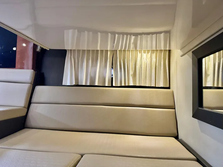 Clintessa Yacht Photos Pics Interior cabin of 2012 Regal 35 Sport Coupe with beige seating and curtains.