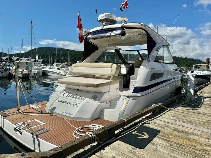 Clintessa Yacht Photos Pics 2012 Regal 35 Sport Coupe docked at marina, sunny day, flags flying.