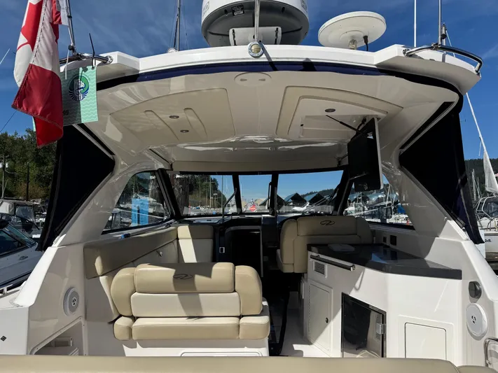 Clintessa Yacht Photos Pics 2012 Regal 35 Sport Coupe interior with beige seating and modern amenities.