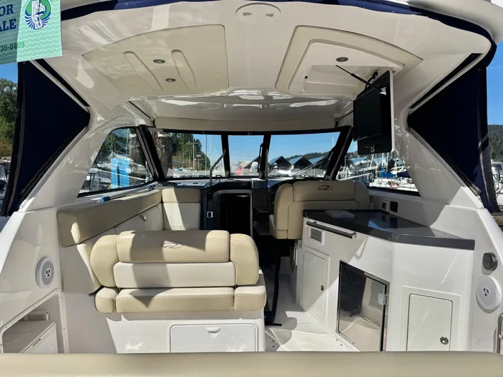 Clintessa Yacht Photos Pics Interior of a 2012 Regal 35 Sport Coupe boat with beige seating and modern amenities.