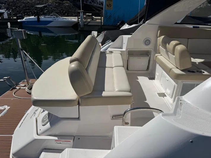 Clintessa Yacht Photos Pics 2012 Regal 35 Sport Coupe boat interior with beige seating at a marina.
