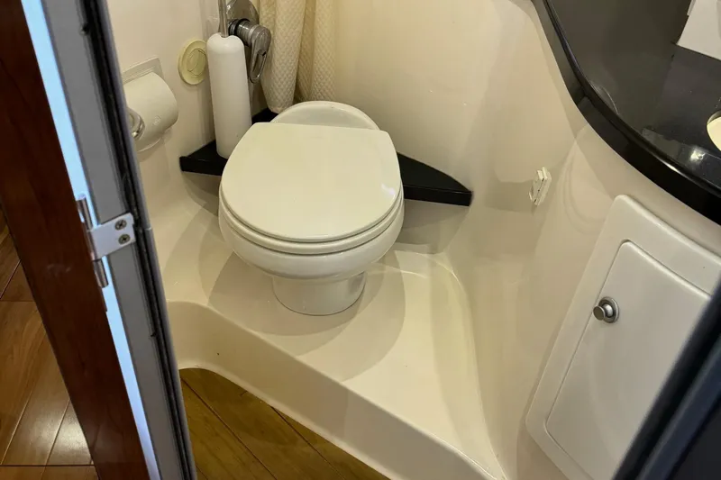 Clintessa Yacht Photos Pics Bathroom interior of 2012 Regal 35 Sport Coupe yacht, featuring a compact toilet.