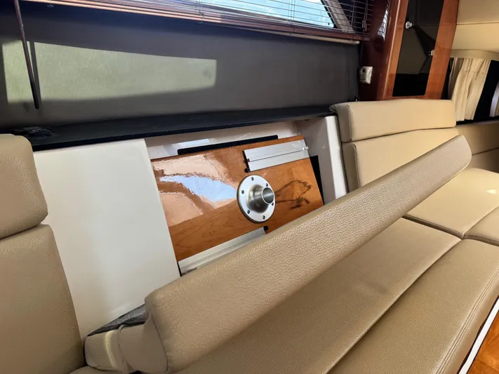 Clintessa Yacht Photos Pics Interior seating of 2012 Regal 35 Sport Coupe with beige cushions and wooden accents.